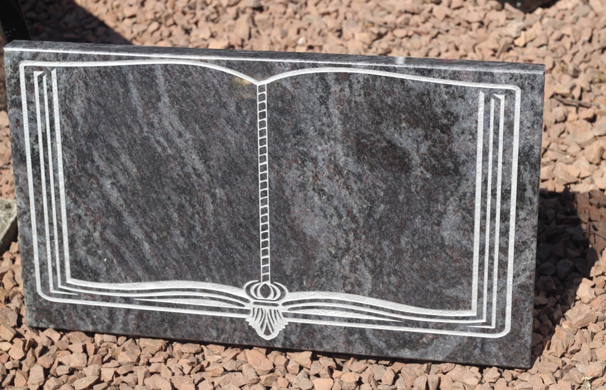 Granite memorial carved as an open book with tasselled bookmark
